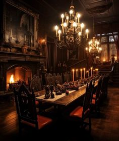 a long table with many candles on it in front of a fireplace and chandelier