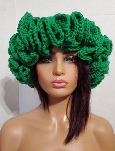 a mannequin head wearing a green knitted hat