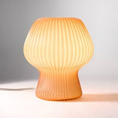 an orange lamp sitting on top of a white table