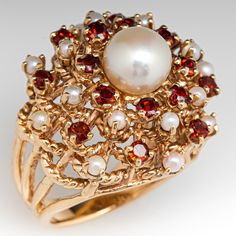 This captivating ring is centered with a post set, cultured saltwater pearl. The top of the ring is four-prong set with sixteen (16) seed pearls and sixteen (16) round single cut garnets. The ring measures 22.5mm at the top, rises 14.2mm above the finger, tapering to 3.7mm wide and 1.4mm thick at the base of the shank. This ring is currently a size 6. Garnet Pearl Ring, Elegant Red Pearl Ring For Anniversary, Faberge Jewelry, Diamond Pendants Designs, Fall Flower Arrangements, Antique Jewelry Rings, Exotic Jewelry, Edwardian Jewelry, Saltwater Pearls