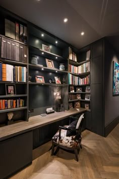 an office with bookshelves, desk and chair in the middle of the room