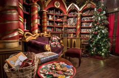 a living room filled with lots of furniture and christmas decorations on top of wooden floors