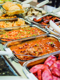 a buffet table filled with lots of different types of food