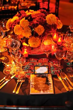 the table is set with flowers and candles