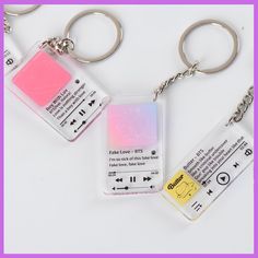 three key chains with tags attached to them