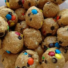 a pile of cookies with m & m's in the middle and candy on top