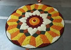 a circular rug made out of flowers on the floor