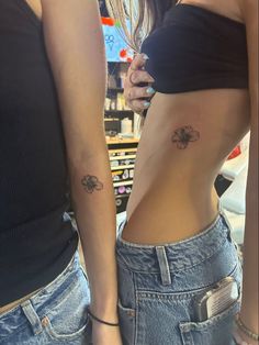 two women with tattoos on their stomachs