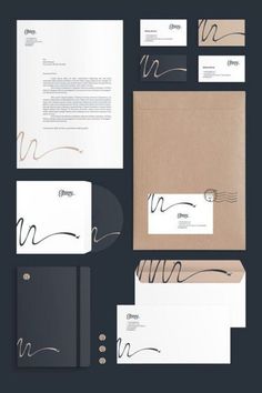 the stationery is laid out neatly on top of each other, including envelopes and business cards