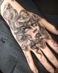 a woman's hand with a tattoo on it