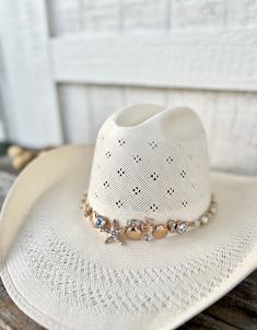 "Embrace your coastal cowgirl glam spirit with this stunning beaded rhinestone Western Hat Band! This hat band is perfect for country concerts or rustic beach weddings. It is centered around a gold plated starfish and shell statement piece and accented with glass crystals and creamy pearls. It is finished with an adjustable extender chain to fit women's cowboy or fedora hats.  🤠 Includes handmade hat band (hat not included in this listing) 🤠 Adjustable size - 23\" design with 3.5\" extender ch