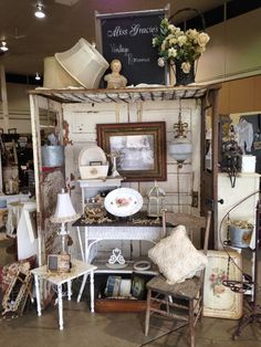 a room filled with furniture and decor inside of a store or showroom that is open to the public