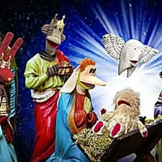 the nativity scene is depicted with three wise men and two sheeps, one holding a baby jesus