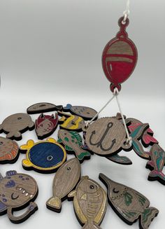 a group of wooden magnets sitting on top of a white table next to each other