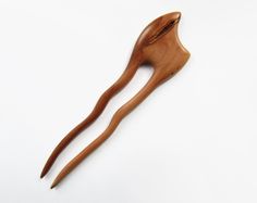 Hand Carved Wooden Hair Fork From the Apple Wood This hair fork is very smooth and easily slide into hair while holding it perfectly in shape. The wood has been treated with natural oil. To finalize the hair fork, it is polished to a high shine. Leaving you with not only a useful and functional tool but also a beautiful decoration for your hair. Great for all hair types: straight, wavy, curly. Works well with shoulder-length hair to very long hair below the waist. Overall length: 5,7 inches (14,5 cm) Functional prong length: 4,3 inches (11 cm) Top wide: 1,3 inches (3,3 cm) Wooden hair fork is not only functional, but also make your hairstyle! Unlike hair ties or metal clips, wooden hair forks will not damage your hair. There are many varieties of hairstyles to play with. For example they c Wooden Hair Clip, Wood Apple, Stick Wood, Pin Hair, Hair Fork, Hang Loose, Natural Oil, Beautiful Decoration, Hair Stick