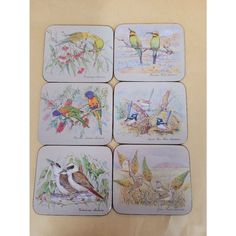 four coasters with birds painted on them