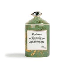 a green bottle with an eye on top and the words capricorn written in it