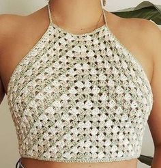 a woman wearing a crocheted crop top