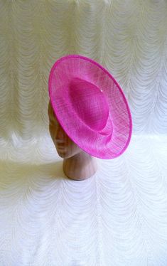 One contoured saucer with an upturned brim hat sinamay straw fascinator / hat base in fuchsia pink that measures approximately 12" (30.5 cm) in diameter. The base is contoured to fit against the head. The edges of the brim are finished in sinamay. The multi-layer stiffened sinamay straw has a great sturdy weave and provides excellent support for your millinery creations. This is NOT a ready to wear finished hat and it will not stay on your head unless you add a head band to wear. Add embellishments of your choice. Sinamay is a natural material and you may see some color striations in the weave. This is not a defect, but is the result of how different natural fibers respond to dye. A nice high quality base - I know you'll be pleased! This hat base is listed separately in navy, yellow, white Cheap Pink Hats For Fall, Cheap Pink One Size Hats, Affordable Pink Fall Hats, Cheap Pink One-size Hats, Cheap One Size Pink Hats, Pink Hat With Adjustable Fit, Cheap Pink Mini Hats For Spring, Cheap Playful Pink Hats, Cheap Pink Mini Hats For Party