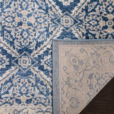 two blue and white rugs on the floor next to each other with an area rug underneath them