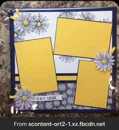 two yellow and blue cards with daisies on them, sitting on a marble surface