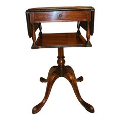 an antique wooden table with one drawer on the top and two legs at the bottom