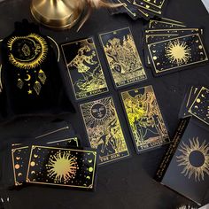 the tarot cards have been placed on top of each other and are gold foiled