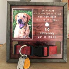 a dog memorial frame with a keychain attached to it and a photo on the front