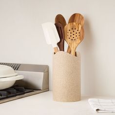 wooden utensils and spatulas in a cup on a counter