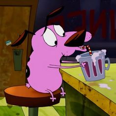 a cartoon character sitting at a table with a cup