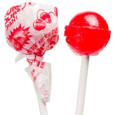 a red and white lollipop on a stick with the wrapper wrapped around it