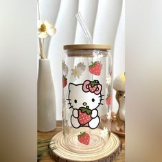 a hello kitty glass jar with strawberries on it