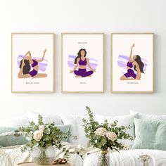 three framed art prints on the wall above a couch with pillows and flowers in vases