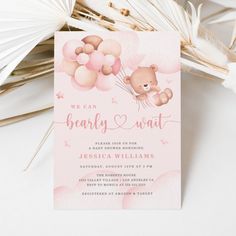 a pink and white baby shower card with a teddy bear holding balloons on it's back