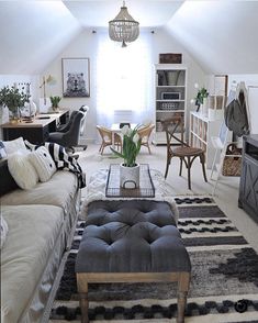 a living room filled with lots of furniture and decor on top of carpeted flooring