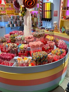 a display in a candy store filled with lots of candies and lollipops