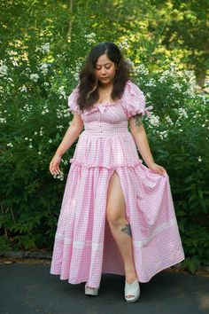 Our Sweet Strawberry Goddess is made with love and grace, and sweetens up the space. Made from lightweight seersucker cotton, it’s perfect for summer days! Featuring puff sleeves sprinkled with daisies, a flattering bodice, pockets and a ruffled bust - this summer twist on our classic Goddess Gown is a must have! Model wearing size M. Skirt length 41 inches on all sizes. Short Sleeve Prairie Dress For Spring Garden Party, Short Sleeve Prairie Dress With Ruffles For Garden Party, Summer Prairie Dress With Puff Sleeves For Garden Party, Puff Sleeve Prairie Dress For Garden Party In Summer, Spring Prairie Dress With Ruffles And Short Sleeves, Summer Cotton Prairie Dress With Gathered Sleeves, Summer Garden Party Prairie Dress With Ruffle Hem, Summer Cotton Prairie Dress With Puff Sleeves, Summer Cotton Prairie Dress With Ruffles