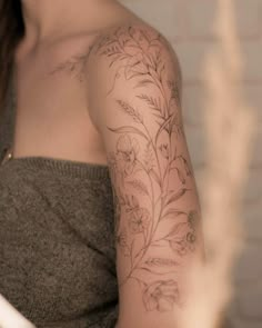 a woman with a flower tattoo on her arm