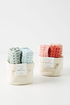 three small baskets filled with different colored towels