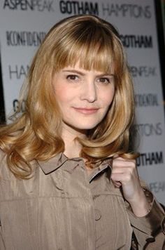 a woman with blonde hair is posing for the camera