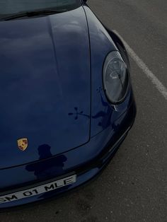 the front end of a blue sports car