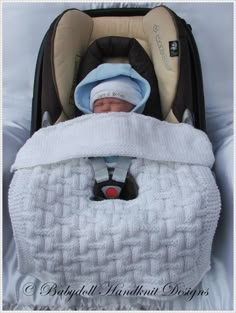 a baby in a car seat with a blanket on it's back and head turned to the side