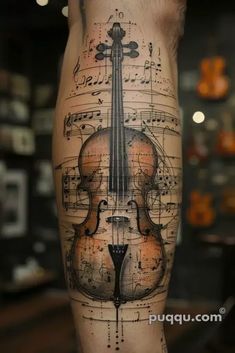 a man's leg with music notes and a violin on it