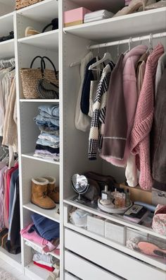 an organized closet with clothes, shoes and handbags on the shelve shelves