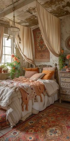 a bed sitting in a bedroom next to a window with drapes on the ceiling