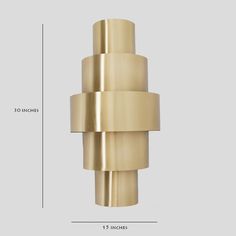 an image of a brass colored object with measurements for the size and width on it