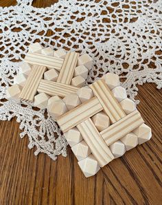 two wooden crosses sitting on top of a doily