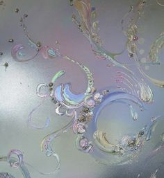 an abstract painting with many different colors and designs on the glass surface, including swirls and bubbles