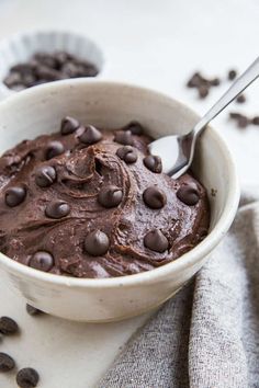 a white bowl filled with chocolate pudding and chocolate chips