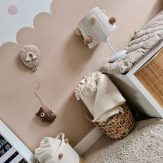 a baby's room with teddy bears and toys on the wall next to a crib